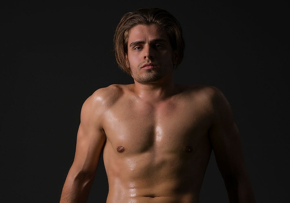 Woman in a stylish black dress, smiling.