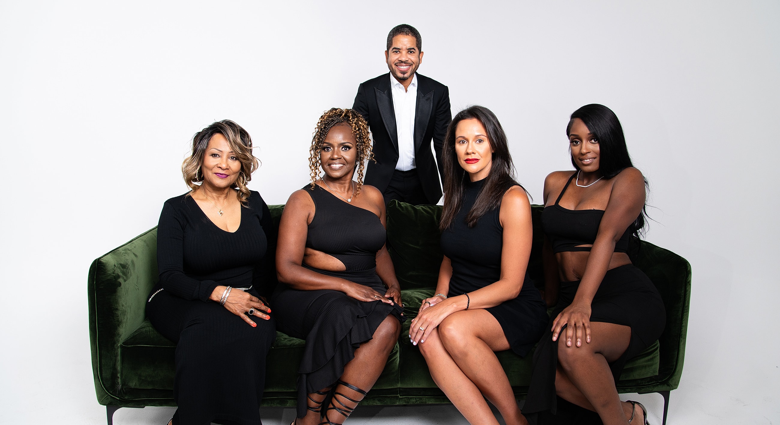 Group portrait of five individuals on a couch.