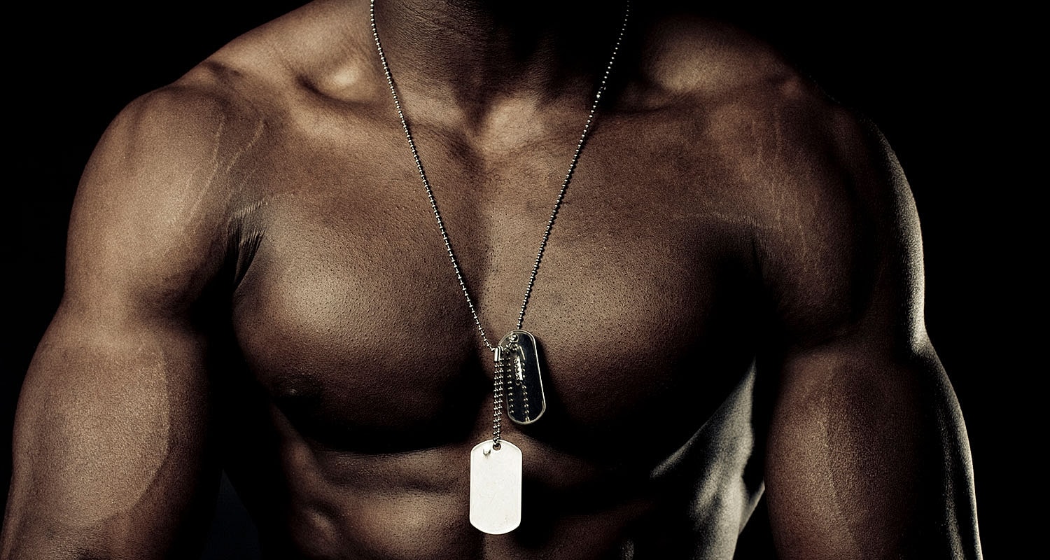 Muscular torso with dog tags necklace.